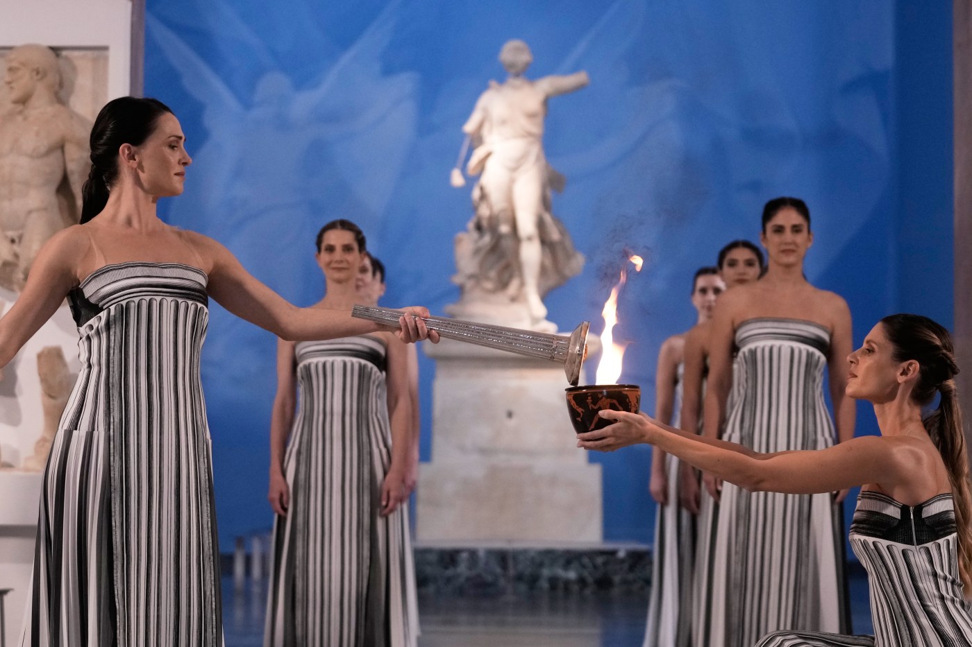 Under a cloud, the Olympic flame begins its journey to the Milan Cortina Winter Olympics
