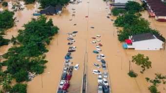 Families in southern Thailand perch on rooftops to escape flooding that has killed at least 33