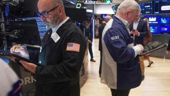 Most US stocks rise with hopes for lower interest rates, but a drop for Nvidia holds the market back