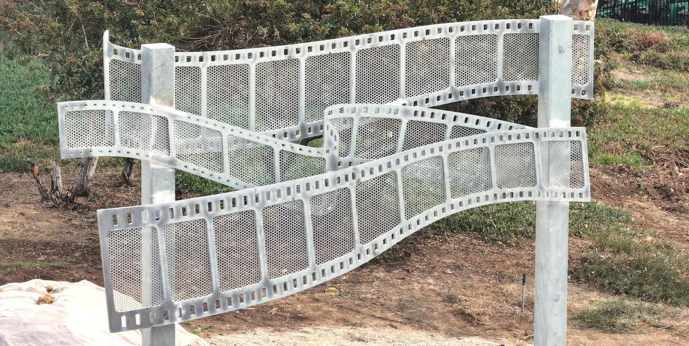 A sculpture honoring movies takes shape on the 101 freeway median in East Hollywood