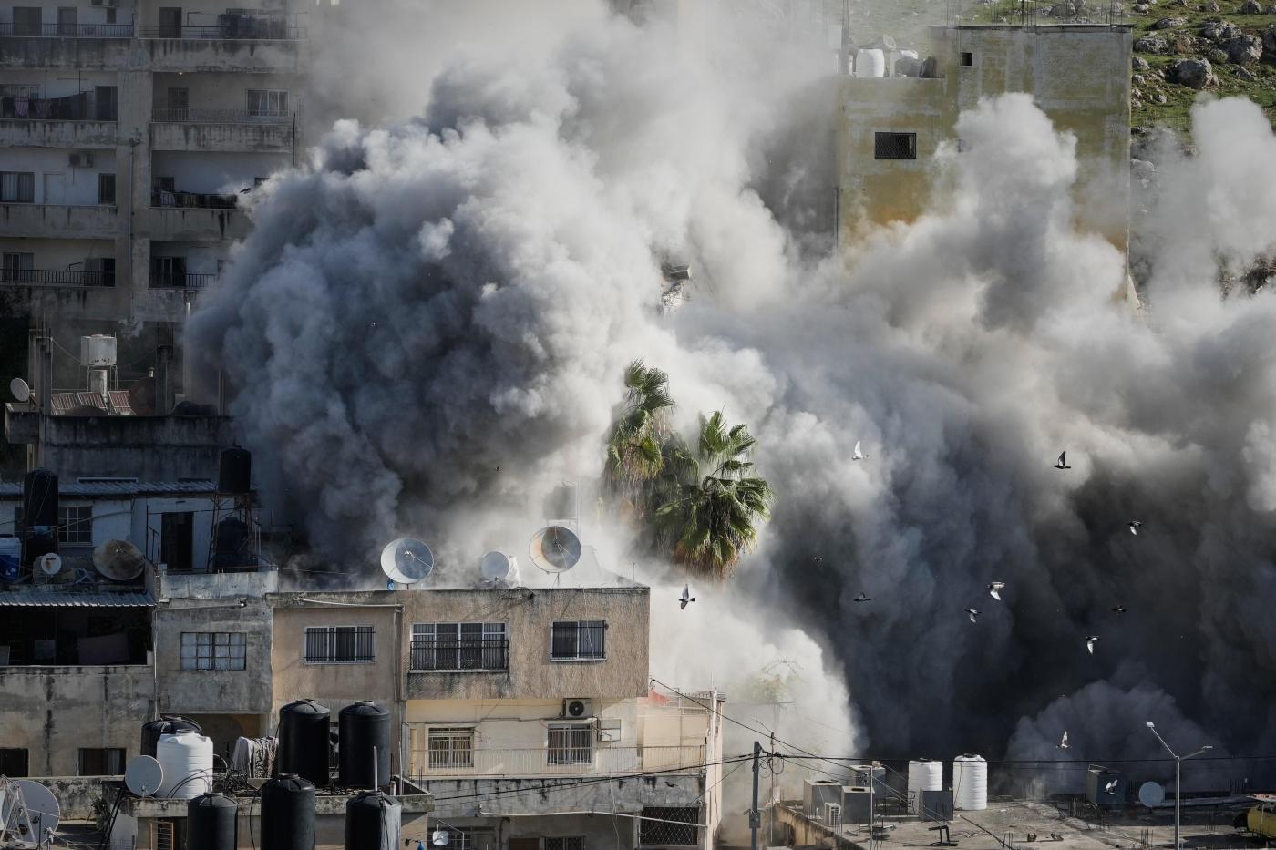 Israeli forensics experts examine remains handed over by fighters in Gaza